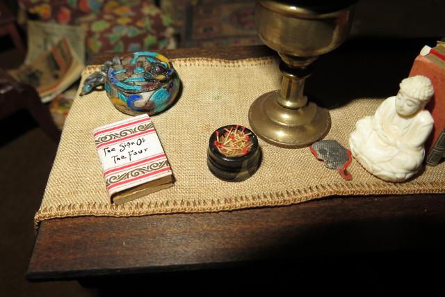 A photograph of a nutshell study of unexplained death showing a detail of a living room.