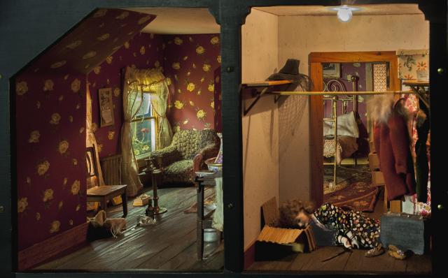 A photograph of a nutshell study of unexplained death showing a detail of a bedroom.