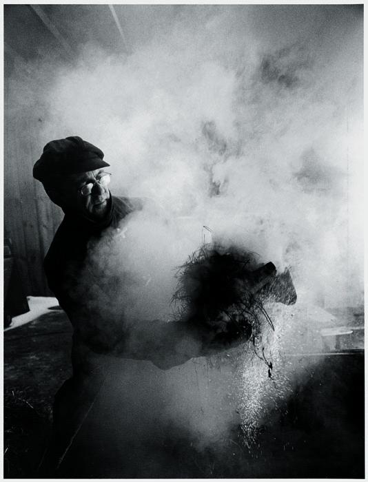 Black and White photograph of Wayne Higby in studio firing work.