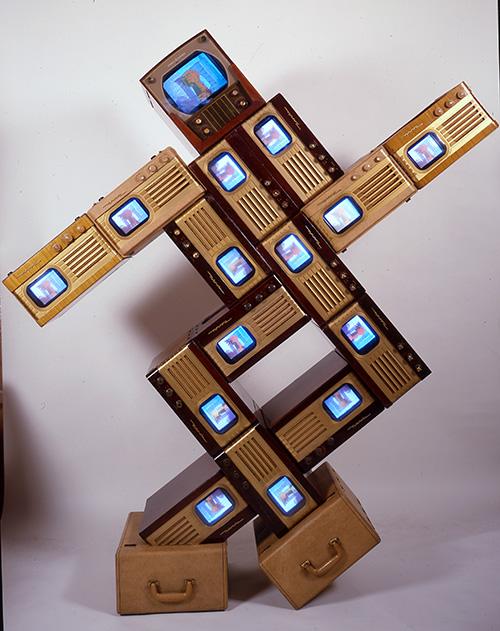 Name June Paik's Merce/Digital made from vintage television cabinets and fifteen monitors.