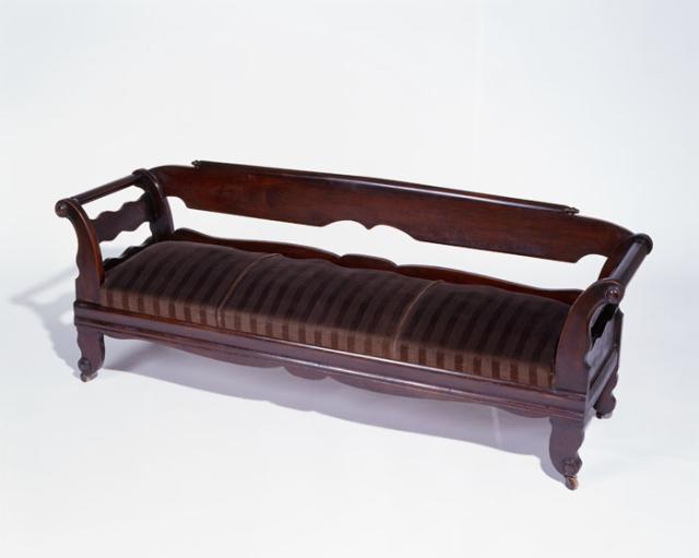 A walnut with yellow pine upholstered lounge.