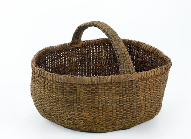 A basket that has circular shape with a handle. 
