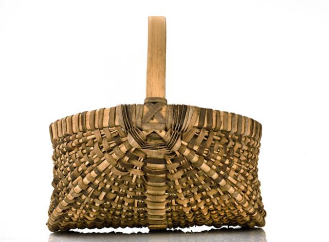 A basket with a circular oval base and a circular handle.