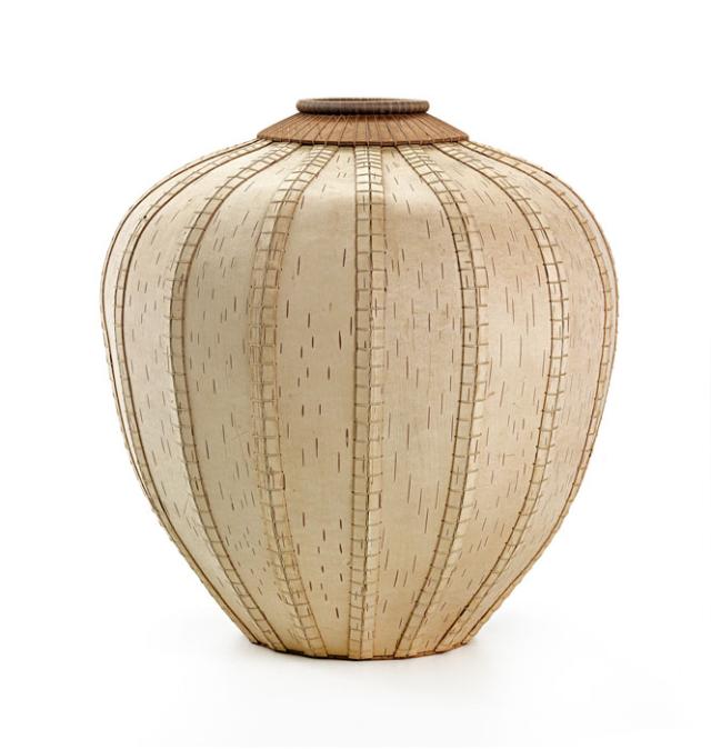 A basket that has a small circular base, a large circular body, and a small circular top.
