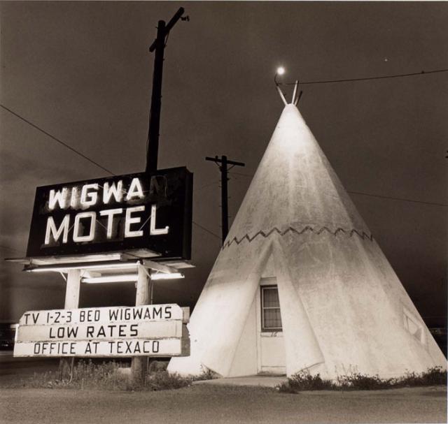 A photograph of a motel in Arizona with a teepee outside. 