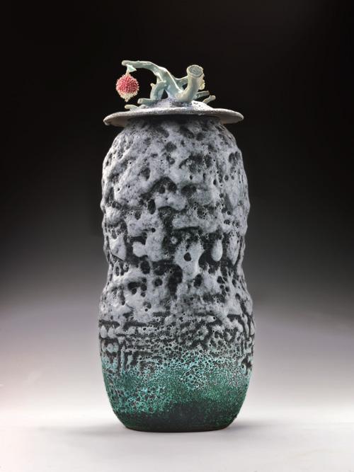 Lee's porcelain urn with a lychee fruit attached at the top.