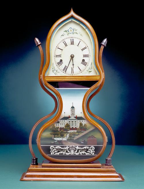 An image of a wooden acorn shelf clock.