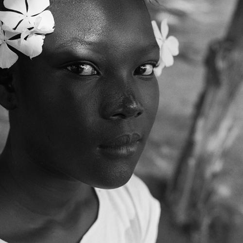 Gleaton's gelatin silver print of a young woman with flowers in her hair.