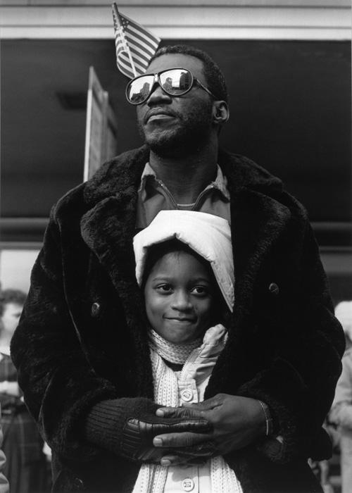 Hudnall's gelatin silver print of a man holding a young girl.