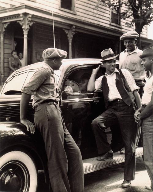 McNeill's gelatin silver print of four men around a car.