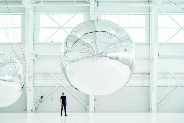 This is a photograph of a white room with large mirrors.
