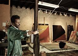 A photograph of Sam Gilliam inside a studio.