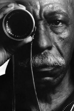 A photo of Gordon Parks looking through a lens