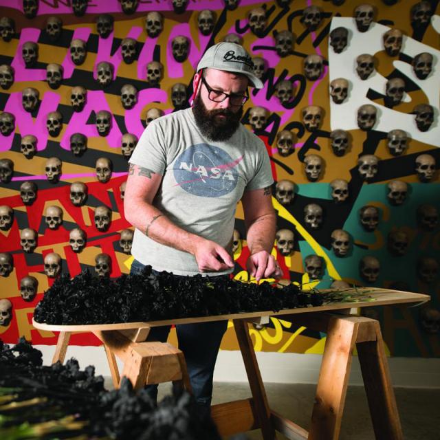 This is a picture of artist Dustin Farnsworth in his studio.