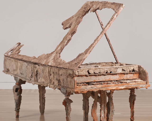 An image of a piano made of clay. 