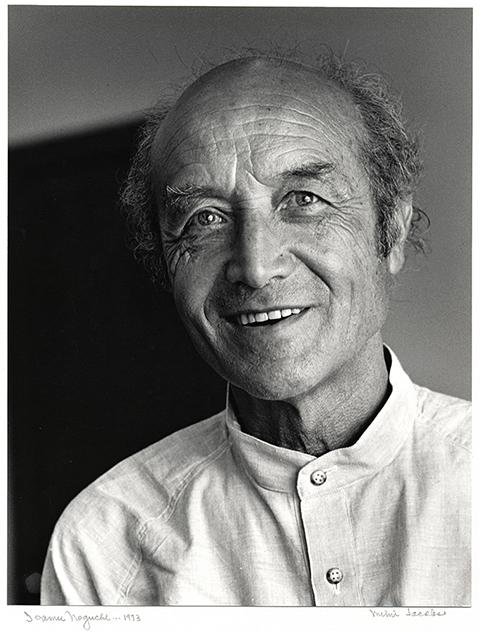 A photograph of a man smiling. 