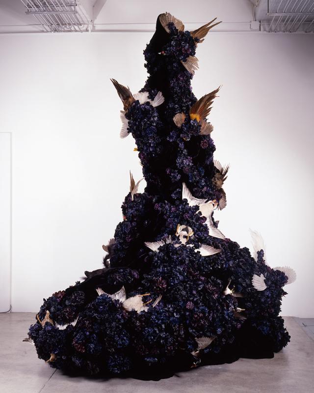 A large black object with white and brown birds on it.