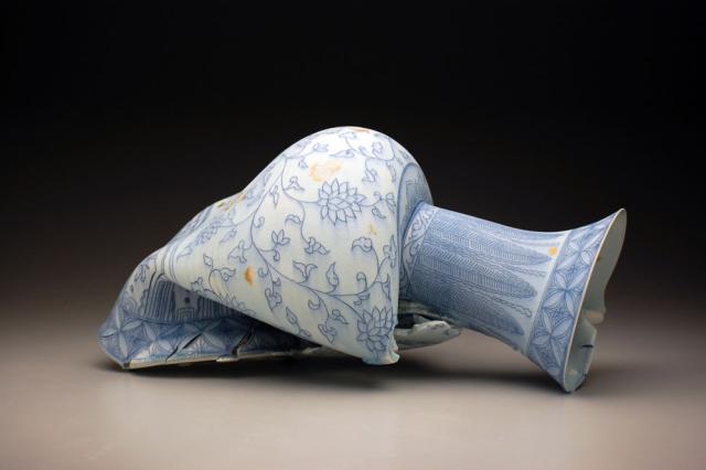 A porcelain vase that's folding in half. 