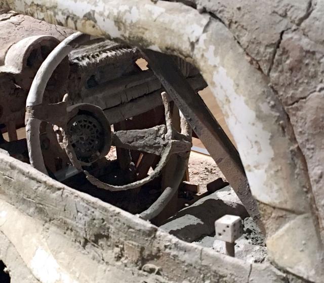 A detail photograph of a steering wheel of a car made of unfired clay. 