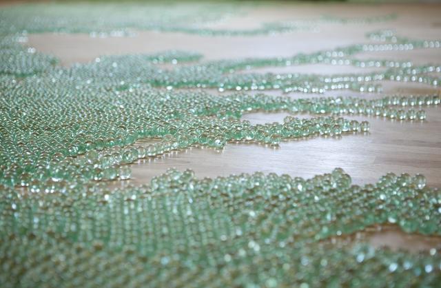 A detailed photograph of marbles on a floor.