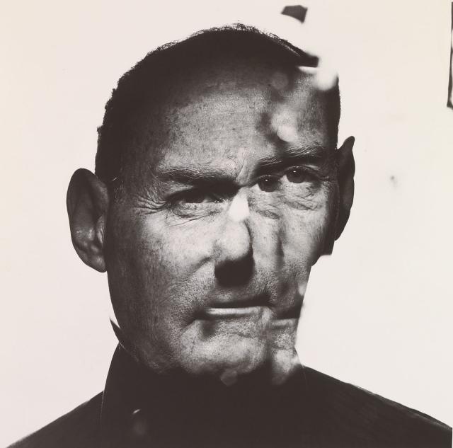 A photograph of Steve Jobs in a cracked mirror.
