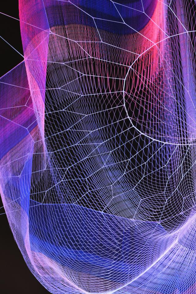 A photograph of colorful mesh hung from the ceiling inside the Grand Salon at the Renwick Gallery.