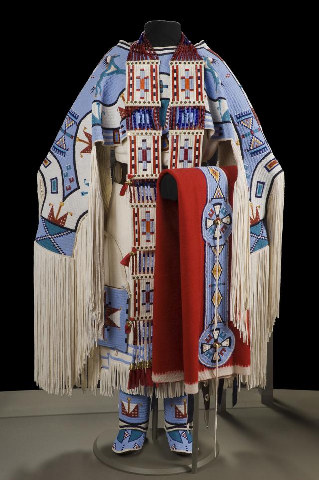 A traditional dress in white, blue, red, and black