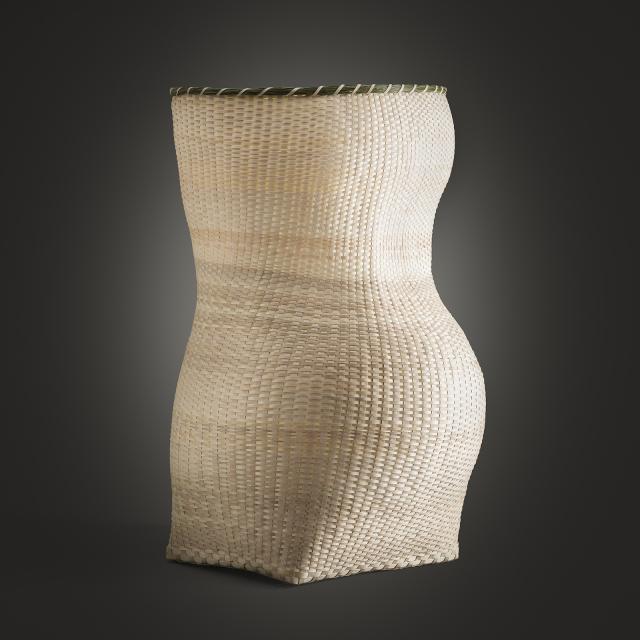 A woven basket in the shape of a female figure.