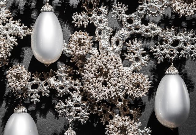 A detail of an artwork with nickel plated bronze and blown glass