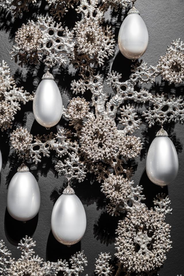 A photograph of a nickel plated bronze and blown glass artwork. 
