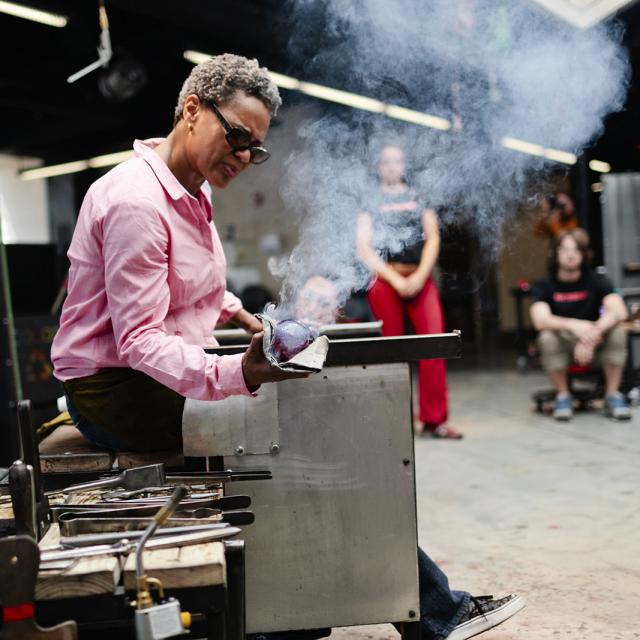 A photograph of an artist in their studio. 