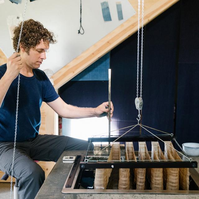 A photograph of an artist in their studio. 