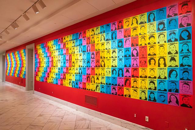 A photograph of a colorful wall with artwork on it