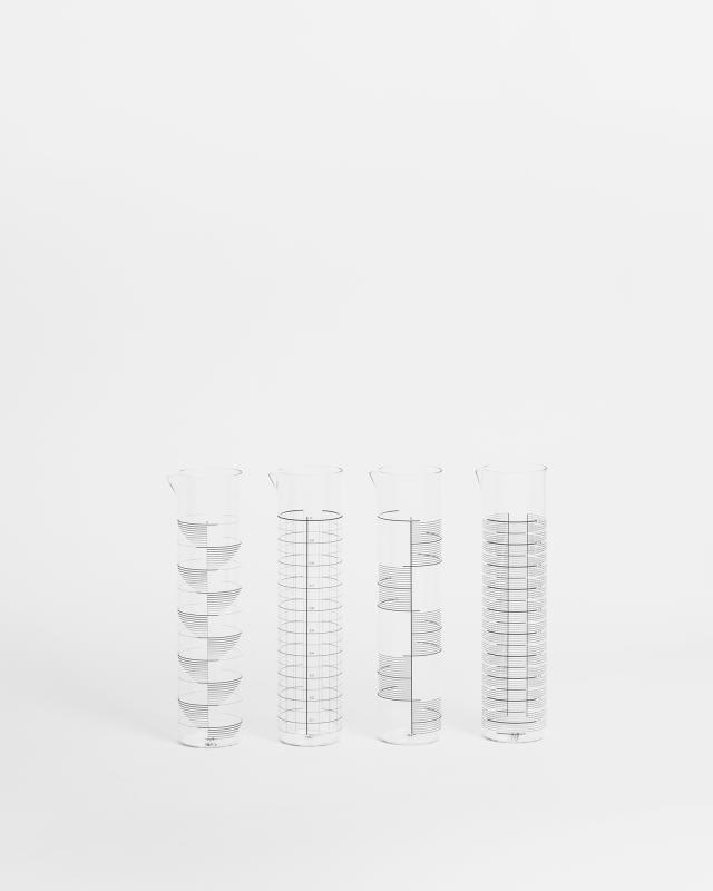 A photograph of four glass objects.