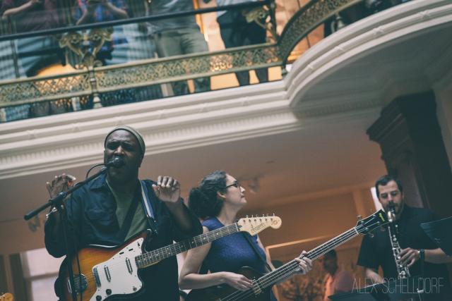 Beauty Pill performs in the Luce Foundation Center. Chad Clark stands in the foreground playing the guitar.