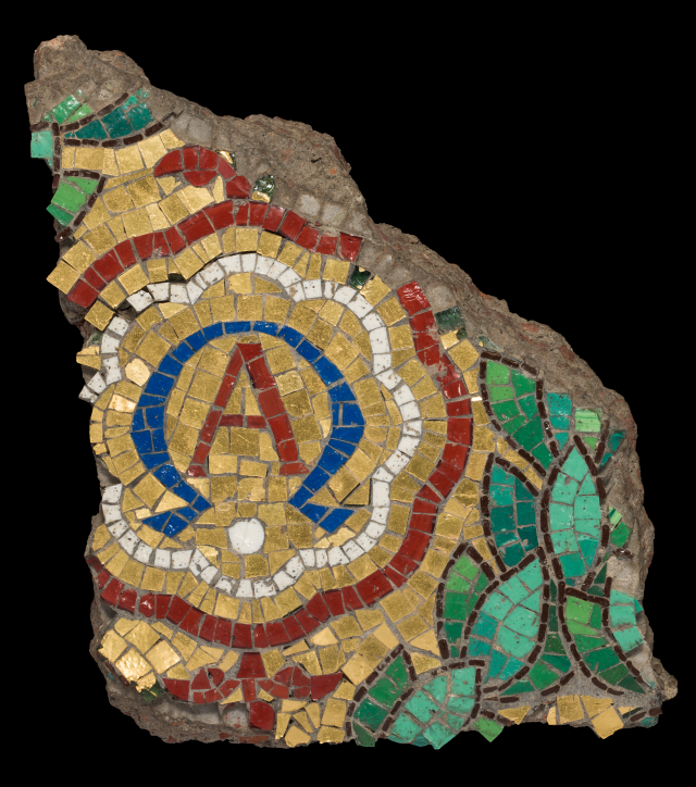 A fragments of a mosaic showing a cluster of leaves and the letter A.