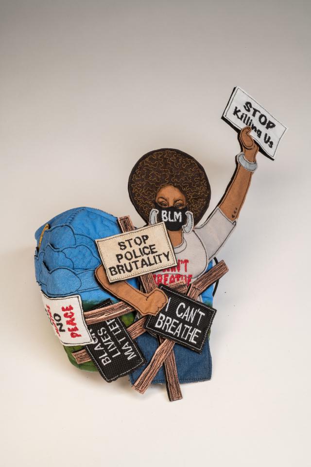 face mask with image of woman protesting for the Black Lives Matter cause