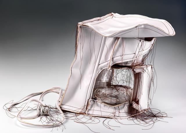Sculpture of crumpled white coffee maker 