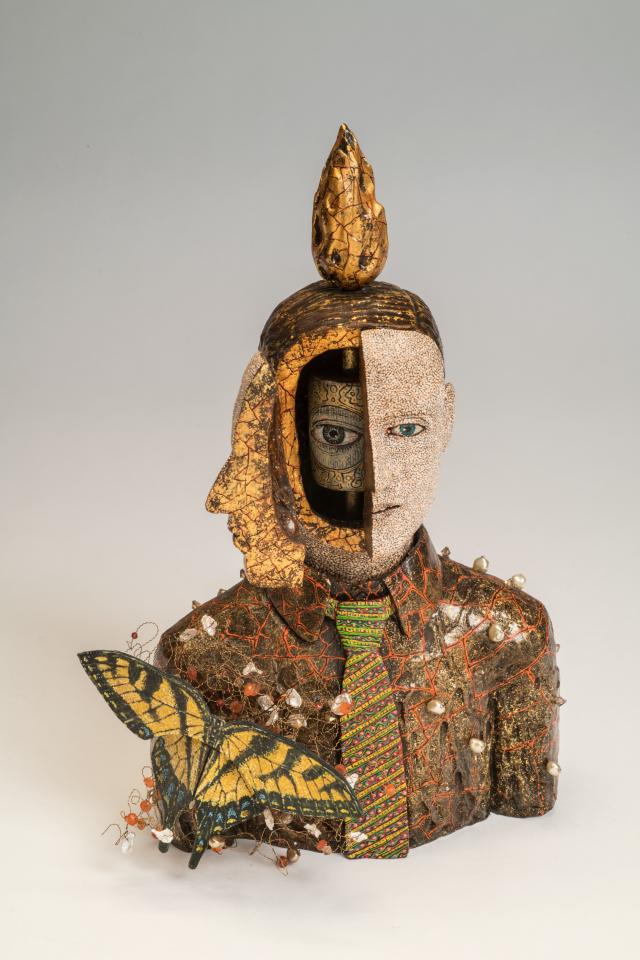 Sculpture of a man's head with compartments. 