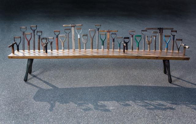 Sculpture of a table with tools and shovels