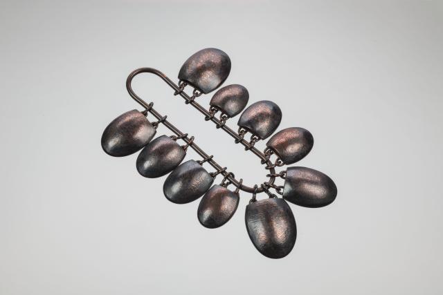 Coper oval adornments on a chain 