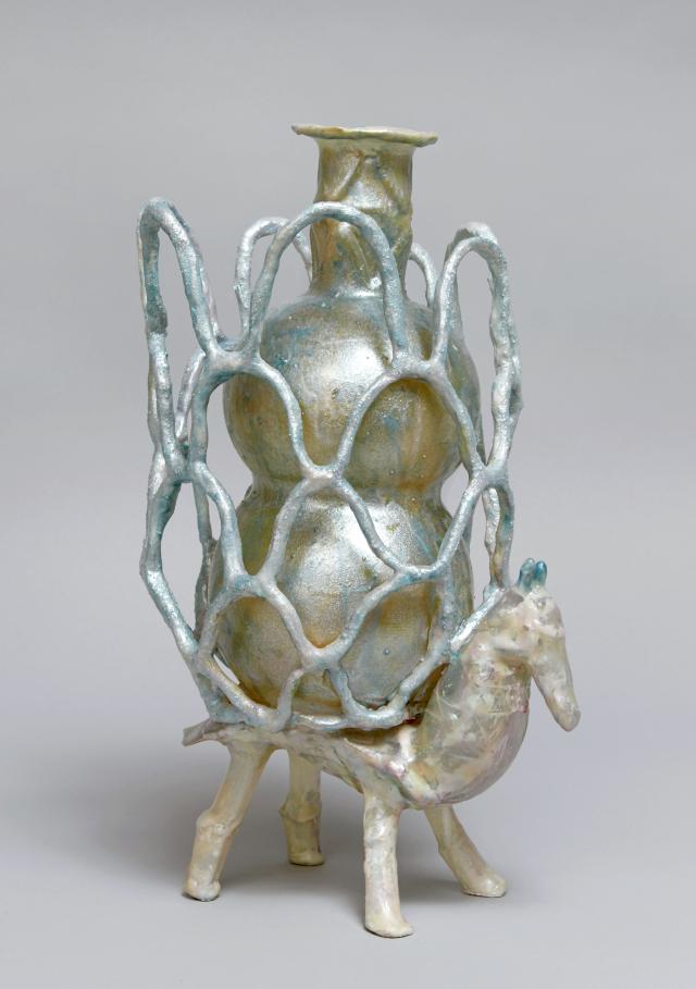 Sculpture of an animal with a caged vessel on its back