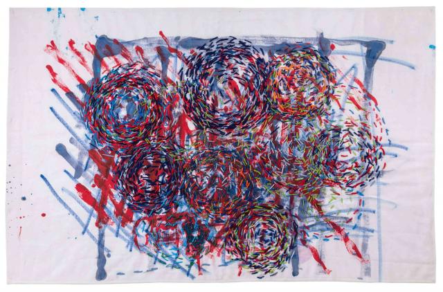 A painted and embroidered abstract artwork in red and blue.
