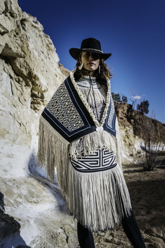 Photo of a woman modeling a handmade, traditional Native American outfit