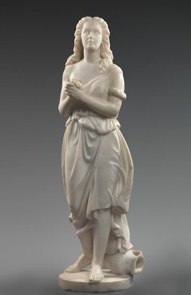Marble statue depicting the biblical figure Hagar, standing with a water pitcher at her feet and her arms crossed in front of her.