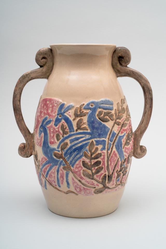 Glazed earthenware vase with blue deer and pink flowers.