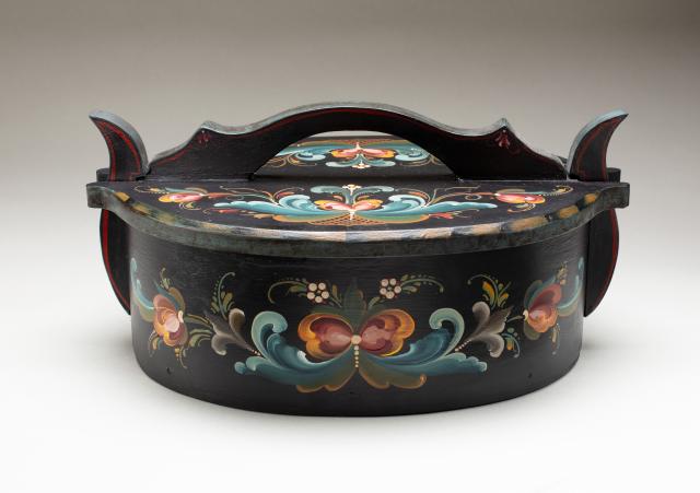 Wooden vessel painted black with a decorative motif.