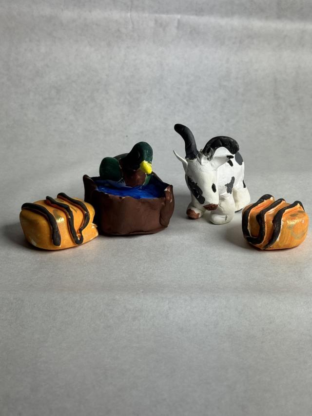 photo of scultpures of a goat and duck looking at fried oreos