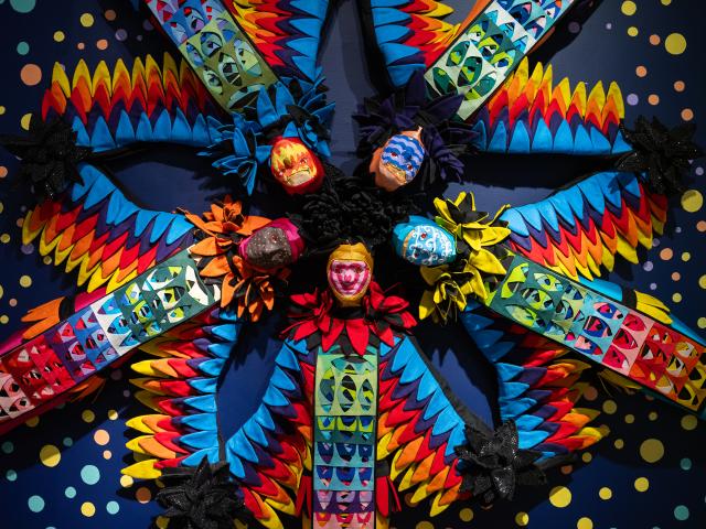 Multimedia art installation with kaleidoscopic projections and mannquins.