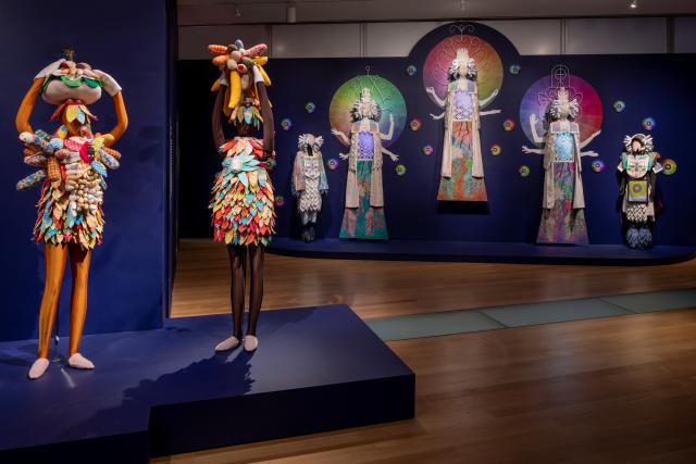 Multimedia art installation with kaleidoscopic projections and mannquins.